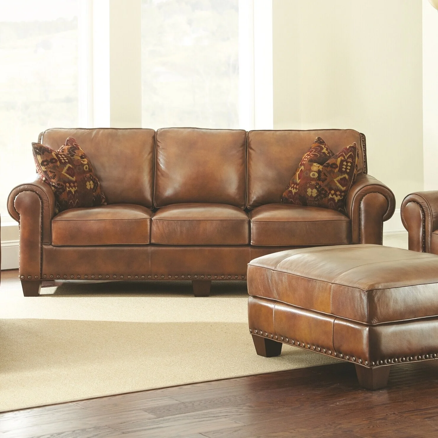 Steve Silver Sanremo Top Grain Leather Sofa with Nail Head Trim and Decorative Pillows